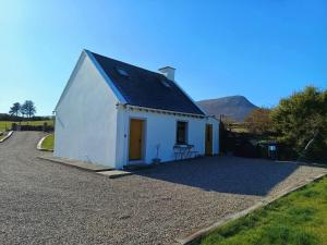 a small white building with a black roof at The WEE HOUS Cresslough in Creeslough +25 photos
