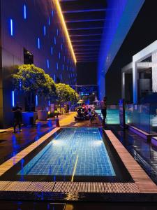 una piscina en medio de un edificio por la noche en PLATINUM SUITES KLCC By RAISA, en Kuala Lumpur