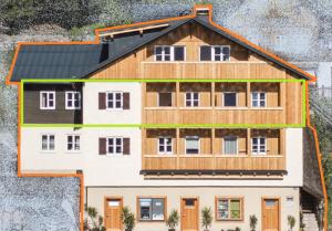 una casa grande con techo negro en MAVIJOLU Lakeside Suites Hallstatt, en Hallstatt