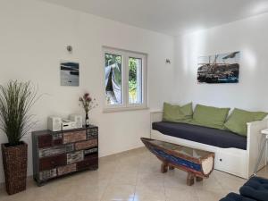 a living room with a couch and a window at Ferienhaus FILI Insel Murter mit privaten Pool und großer Terrasse in Murter