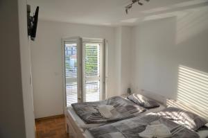 a bedroom with a bed and a large window at Ferienhaus FILI Insel Murter mit privaten Pool und großer Terrasse in Murter +35 photos