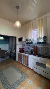 a kitchen with a stove and a counter top at Casa Flores na Janela in Socorro