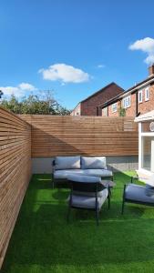 a group of benches sitting on the grass at Crystal Palace Stylish Large Ensuite Double Room in Crystal Palace