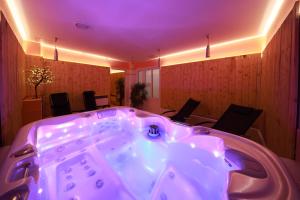 a large hot tub in a room with chairs at Hotel Skicentrum in Harrachov