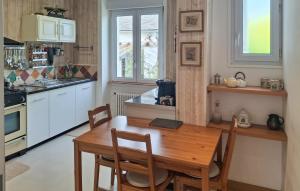 a kitchen with a wooden table and a dining room at 5 Bedroom Lovely Home In Saint-Martin-Des-Champ in Saint-Martin-des-Champs