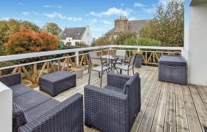 a balcony with a table and chairs on a deck at 5 Bedroom Lovely Home In Saint-Martin-Des-Champ in Saint-Martin-des-Champs