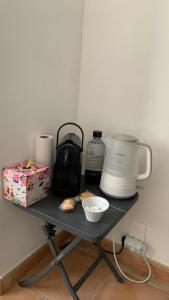 a table with a coffee maker and a box on it at Suite dans maison provençale chez l'habitant in Château-Arnoux-Saint-Auban