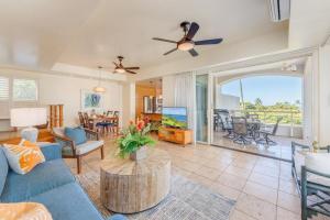 a living room with a blue couch and a table at Palms at Wailea 2108 · PAW 2108 Remodeled Wailea Condo w AC Infi in Wailea