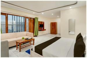 a bedroom with a large bed and a couch at Hotel SR Palace Residency Near Jagannath in Kathmandu