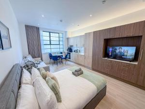 a large living room with a couch and a television at Regents Park 3-BR flat w. balcony near Marylebone in London