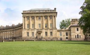 a large building with a grass field in front of it at Pulteney Road Apartment in Bath +49 photos