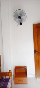 a white room with a fan on the wall at Ovinro rest - Anuradhapura in Anuradhapura