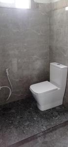 a bathroom with a white toilet in a room at Ovinro rest - Anuradhapura in Anuradhapura