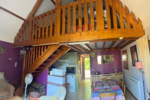 a room with a wooden staircase in a house at Le chalet des Robins in La Bergerie