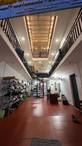 a large room with a staircase and a living room at Mikey House Ha Giang - Tour Operator & Homestay in Làng Xa