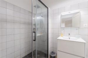 a bathroom with a shower and a sink at Central Narbonne with rooftop terrace in Narbonne +16 photos