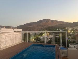 a swimming pool on a balcony with a mountain at תכלת במושבה Lite Blue in the colony in Migdal