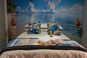 a bedroom with a large bed with towels on it at El-Tsuri Guest Resort in Pretoria +91 photos