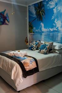 a bedroom with a bed with a painting on the wall at El-Tsuri Guest Resort in Pretoria