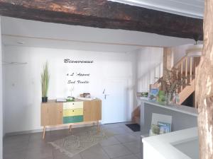 a living room with a staircase and a table at L'Appart Sud Vendée in Saint-Hilaire-des-Loges +10 photos