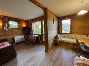 a living room with a couch and a table at Appart 4 pers, accès direct pistes, terrasse, 50m remontées - FR-1-356-426 in Valmorel