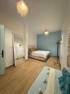 a bedroom with a bed and a large mirror at Appartement a ksar SGHIR en face du terminal passagers de Ferry port Tanger Med in Ksar es Sghir