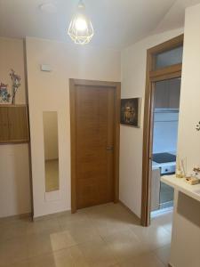 a hallway with a wooden door and a window at Ático La Quinta Esencia in Negreira