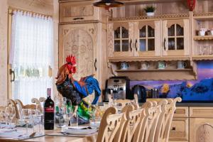 a kitchen with a table with a chicken statue on it at Zasypane Premium House & Sauna in Zakopane by Renters Prestige in Zakopane