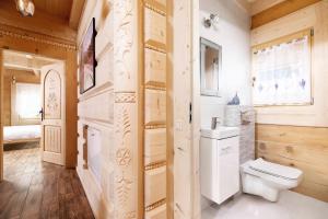 a bathroom with a toilet and a sink at Zasypane Premium House & Sauna in Zakopane by Renters Prestige in Zakopane