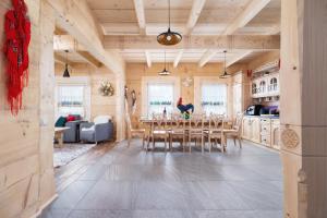 a kitchen and dining room with a table and chairs at Zasypane Premium House & Sauna in Zakopane by Renters Prestige in Zakopane