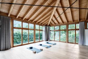 a room with four meditation mats in front of windows at DAS RONACHER Thermal Spa Hotel in Bad Kleinkirchheim