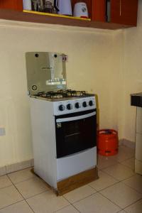 a white stove in a kitchen with at Zariah Homes in Kakamega