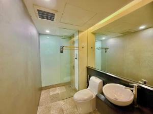 a bathroom with a toilet and a sink at NuEmpire Subang Suite - Empire Hotel in Subang Jaya