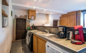 a kitchen with a sink and a counter top at Le Prieuré de Saint Sauveur - Séjour Nature & Détente in Comps-la-Grand-Ville