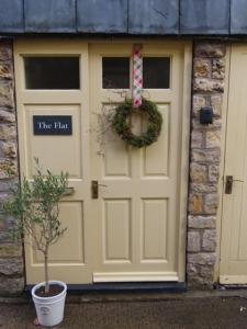 a door of a building with a plant in front of it at The Flat in Broughton