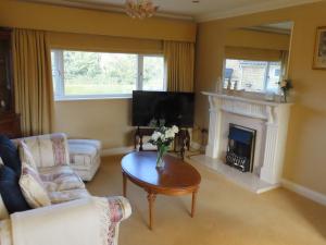 a living room with a table and a fireplace at The Flat in Broughton