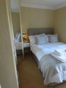 a bedroom with two beds and a mirror at The Flat in Broughton +8 photos