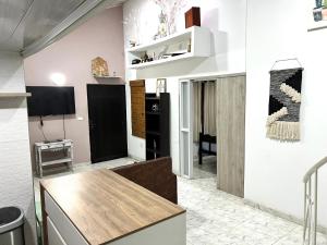 a kitchen with white walls and a wooden table at Como en casa apartment in Cali