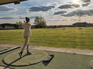 a woman is flying a kite in a park at Hotel Mercure Parc du Coudray - Barbizon in Le Coudray-Montceaux +169 photos