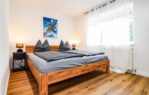 a bedroom with a large wooden bed with a window at Apartment in Inzing in Inzing