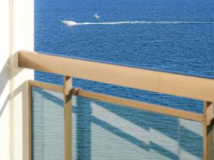 a boat in the ocean viewed from a cruise ship at Pullman Cannes Mandelieu in Mandelieu-La Napoule +172 photos