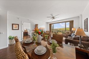 a living room with a table and chairs and a couch at Honua Kai K1024 · HK K1024 Kaanapali Beach Condo Resort Living R in Lahaina