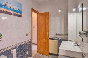 a bathroom with a sink and a wooden door at CASA FILO VISTAS MONTAÑa in Rute +16 photos