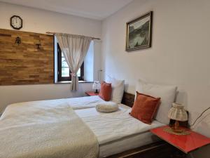 a bedroom with a bed and a clock on the wall at Slovenian House Vida in Bled