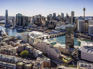 an aerial view of a city with a river and buildings at Novotel Sydney Darling Harbour in Sydney