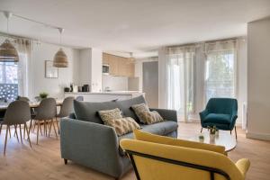 a living room with a couch and a table at Le Duplex - Disneyland - Rooftop - Wifi in Montévrain