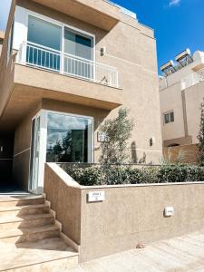 a house with a staircase in front of it at Modern Escape Villa in St Julian with Pool by ArcoBnb in St Julian's