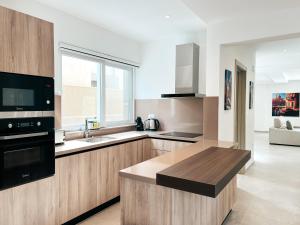 a kitchen with a sink and a counter top at Modern Escape Villa in St Julian with Pool by ArcoBnb in St Julian's