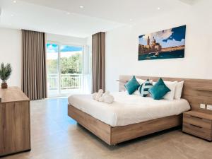 a bedroom with a large bed and a large window at Modern Escape Villa in St Julian with Pool by ArcoBnb in St Julian's +32 photos
