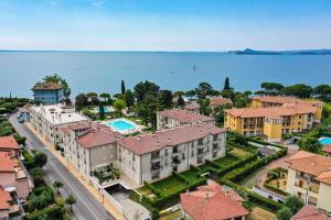 an aerial view of a city with houses and the water at Relais Fasanella attico - Lago di Garda in Toscolano Maderno